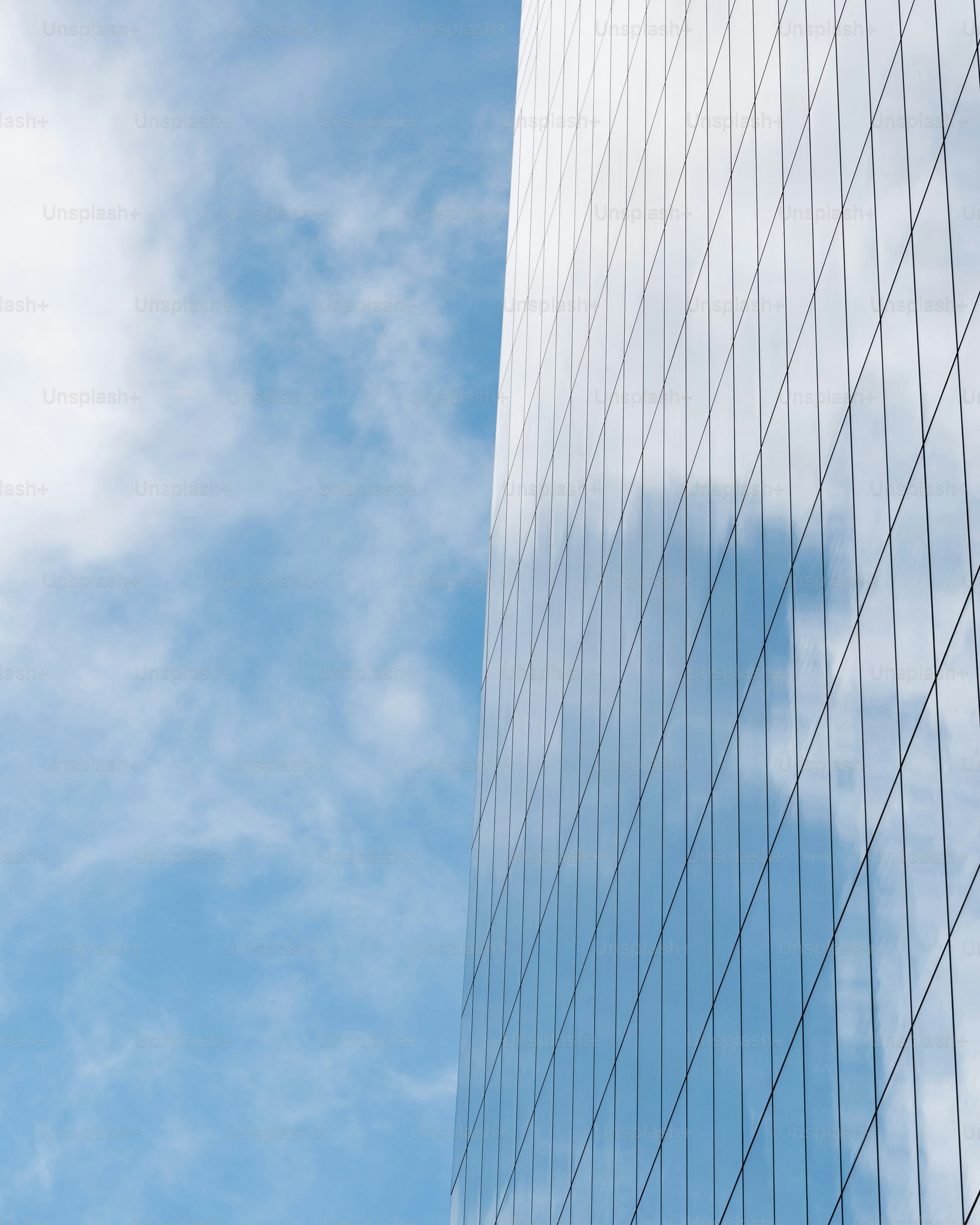 a plane flying in the sky next to a tall building