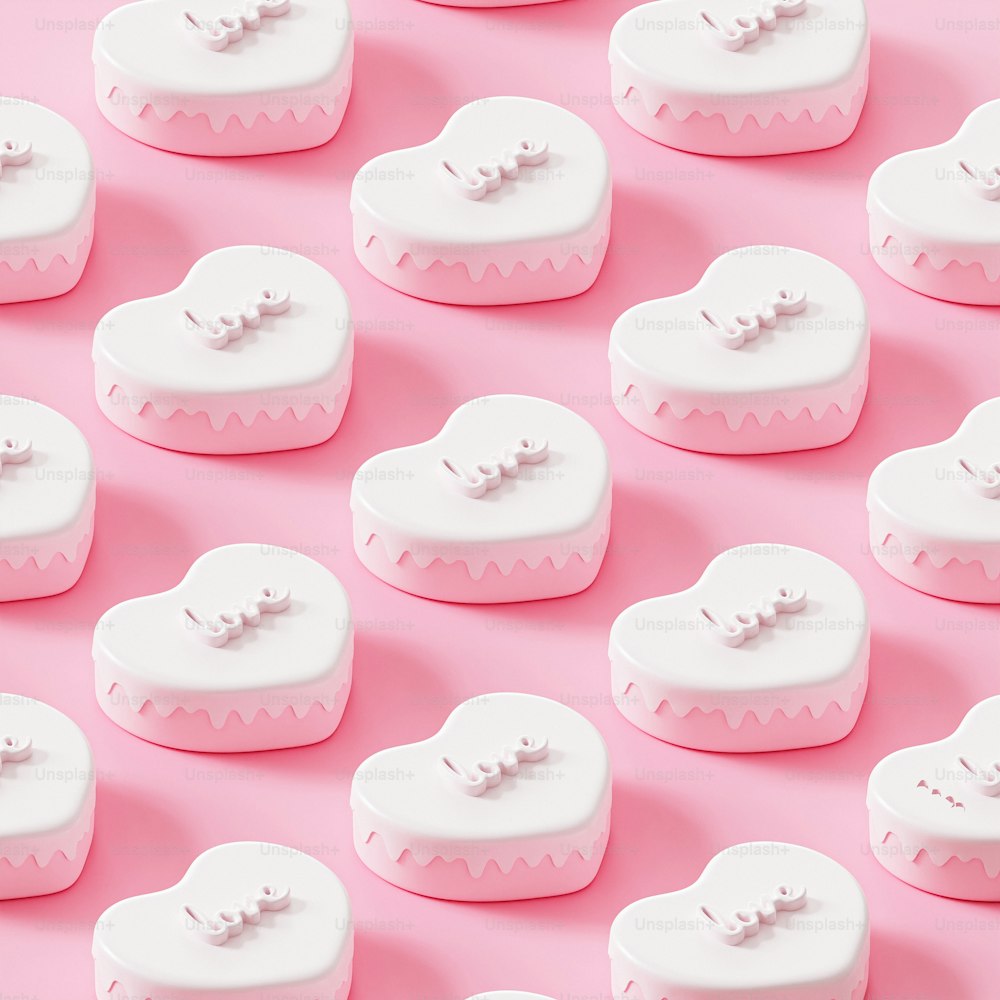 a group of white and pink hearts on a pink background