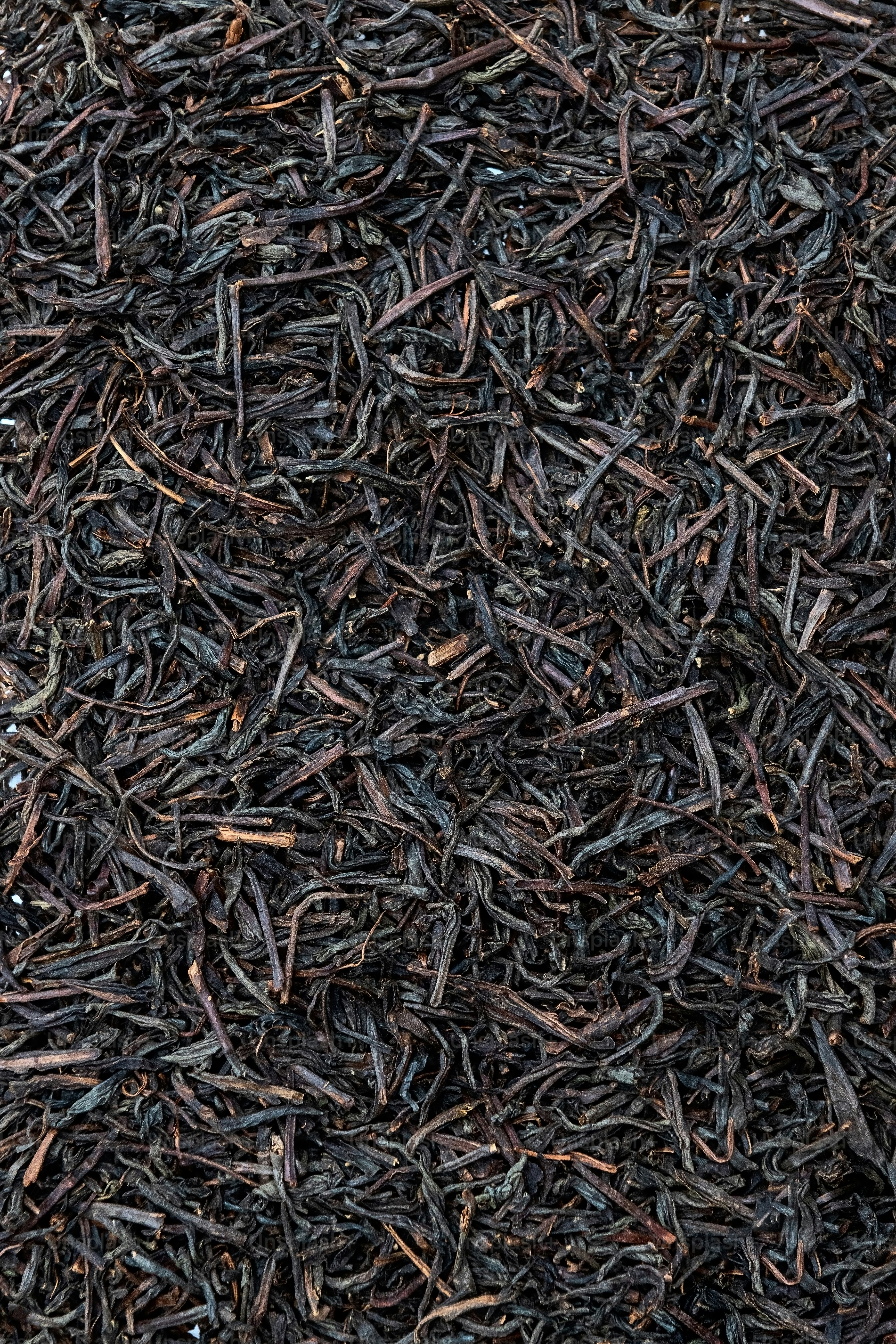 a close up of a pile of black tea