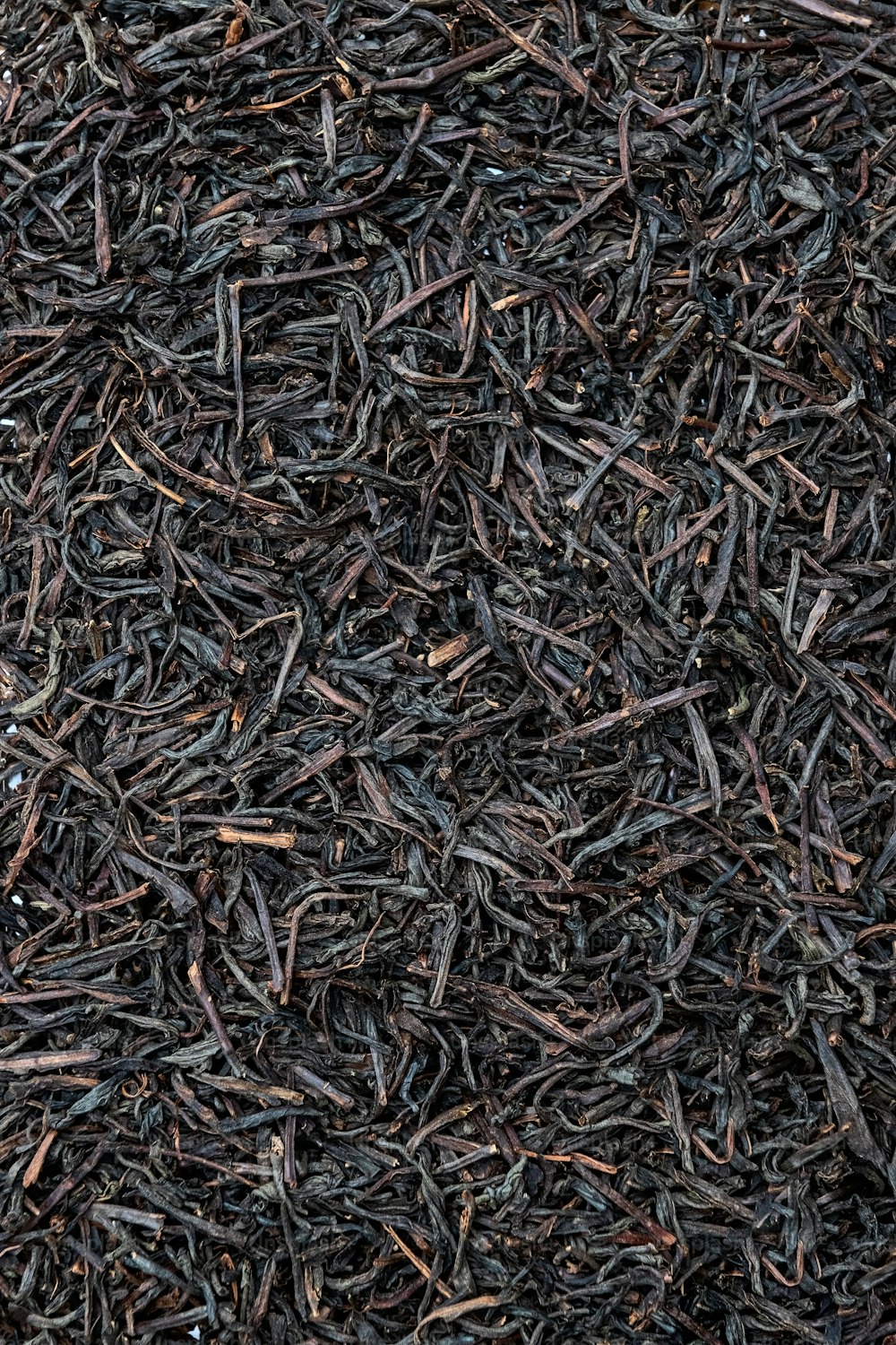 a close up of a pile of black tea