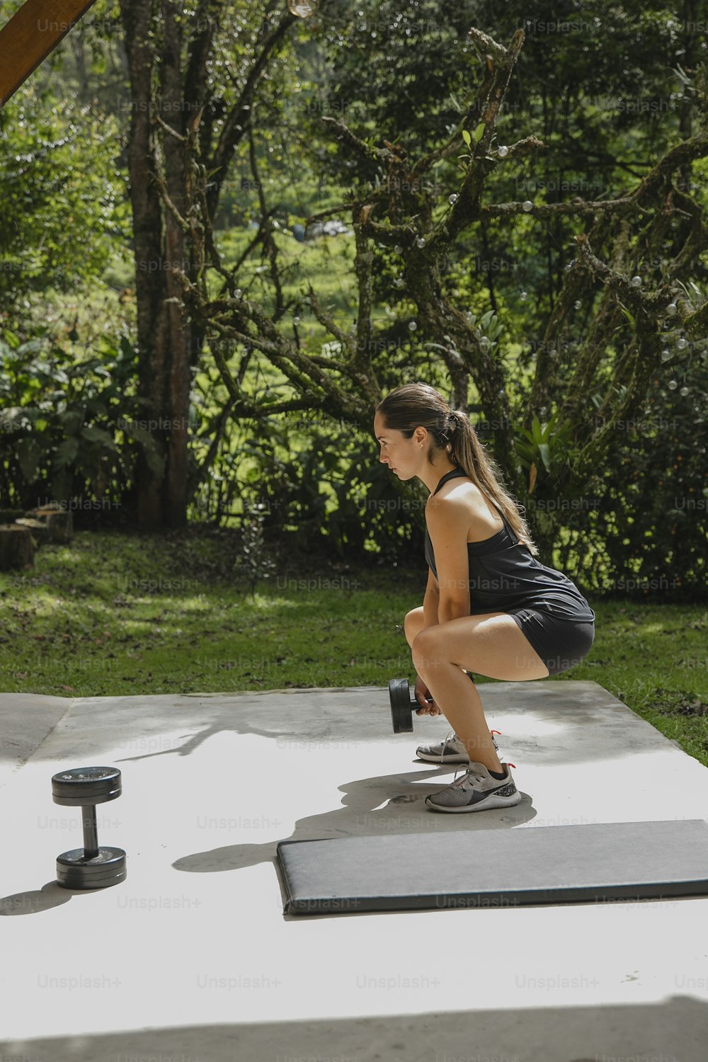 a woman doing squats on a yoga mat