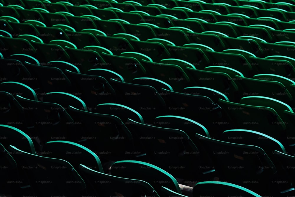 a row of green seats in a stadium