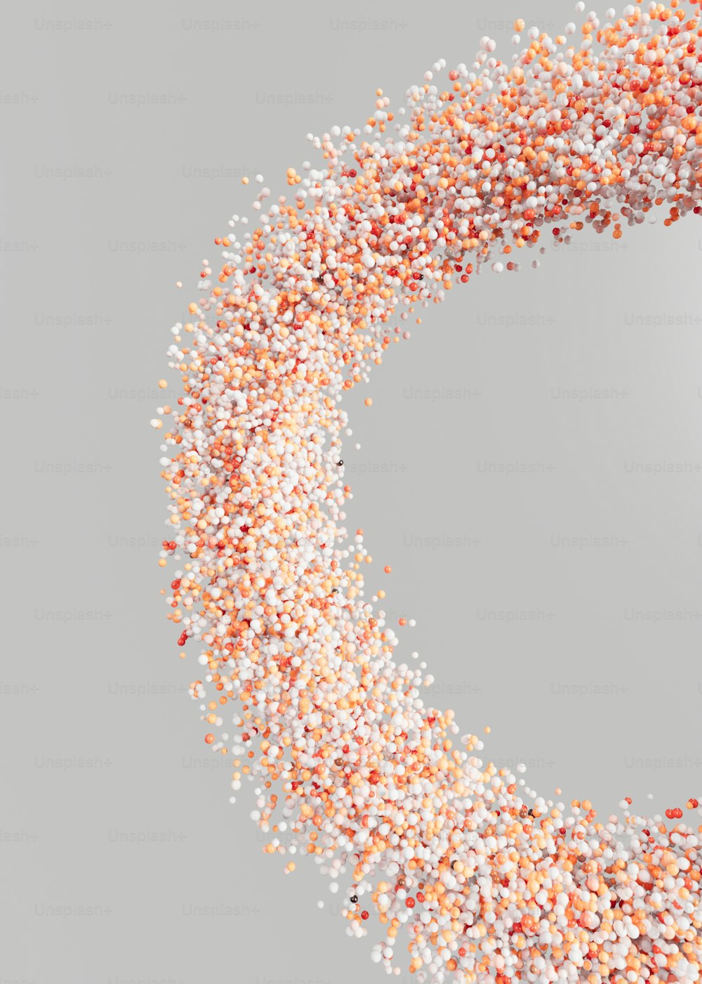 a circular frame made up of small white and orange sprinkles
