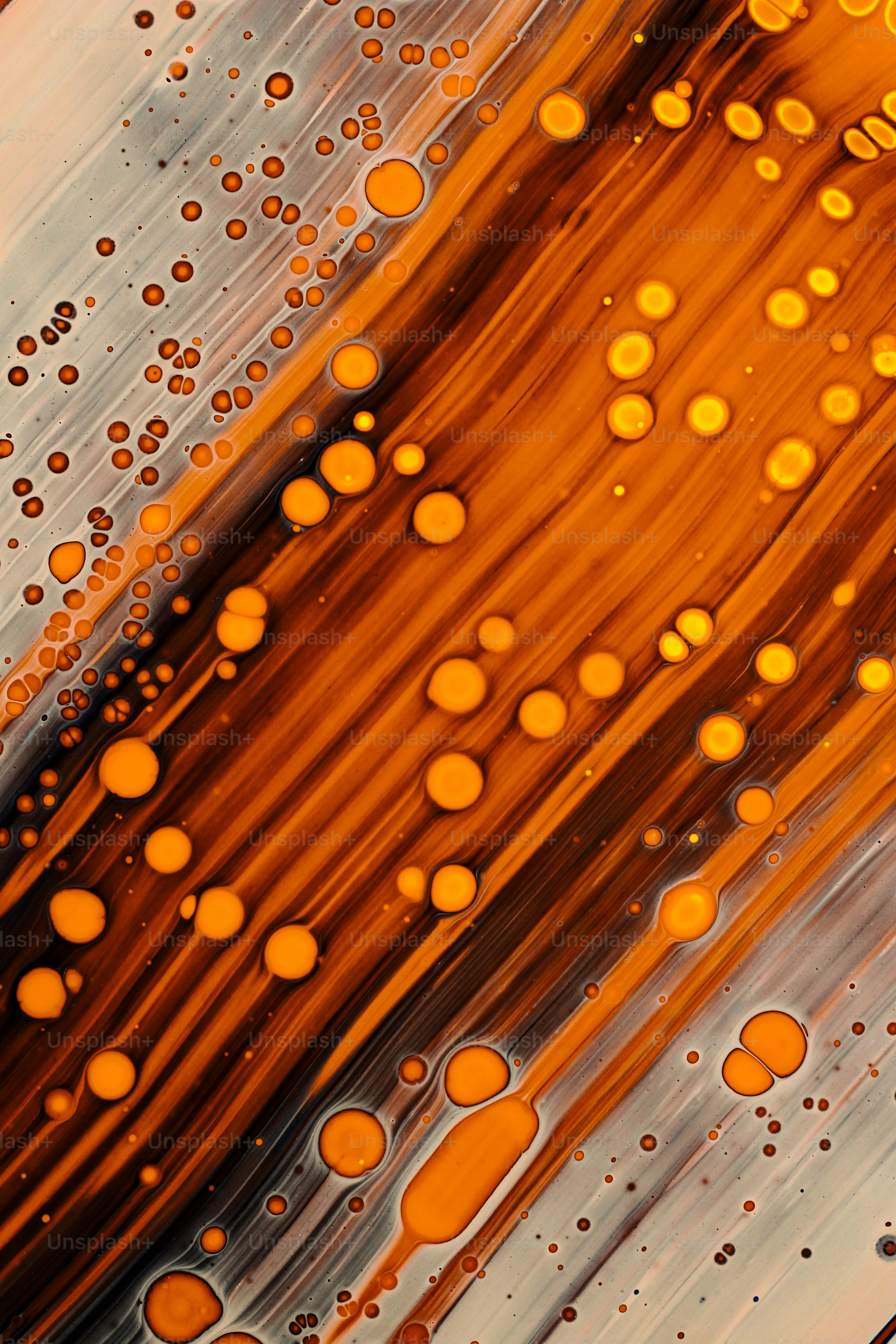 an abstract painting with orange and brown circles
