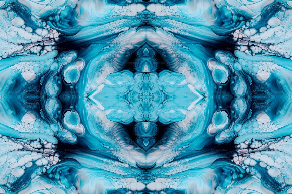 a blue and white abstract design with a large flower in the center