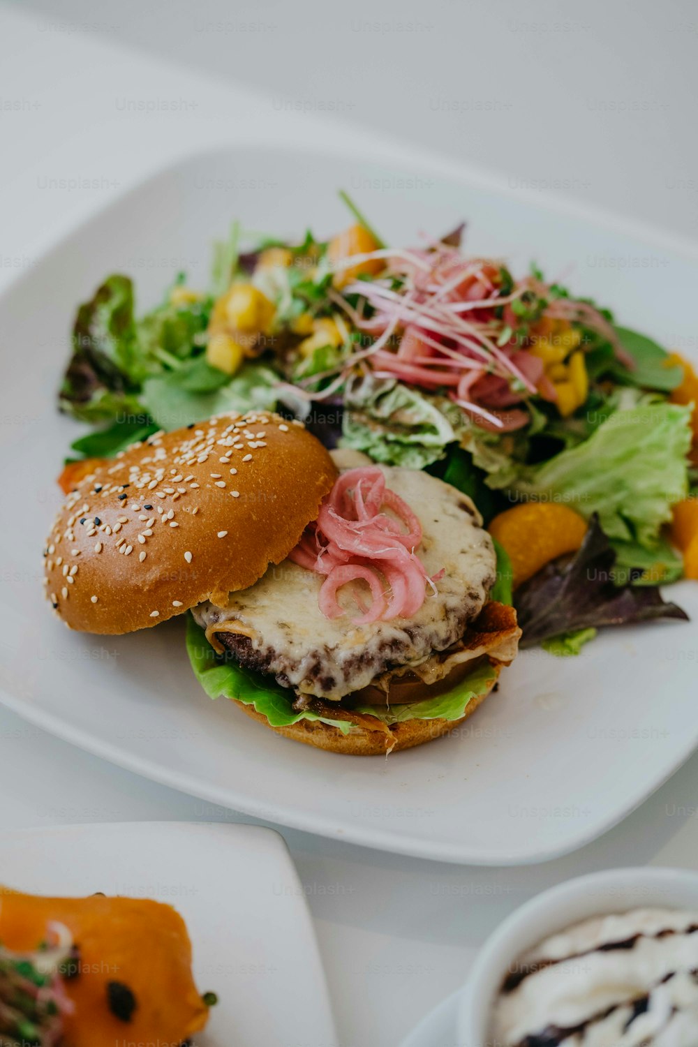 ein weißer Teller mit Sandwich und Salat