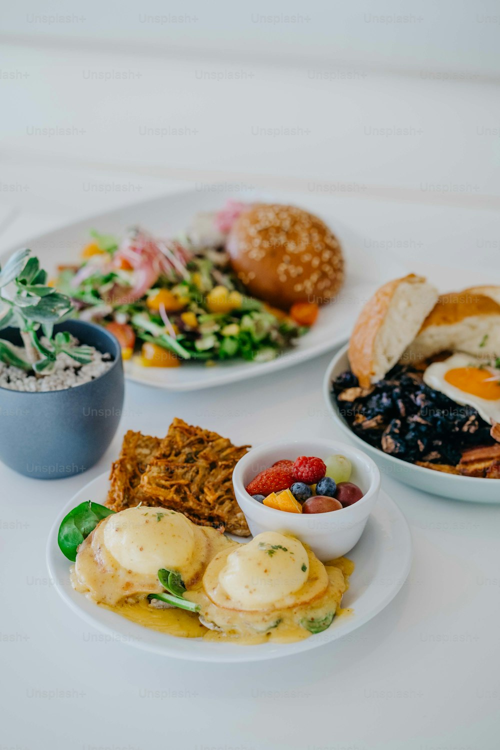 a white table topped with plates of food