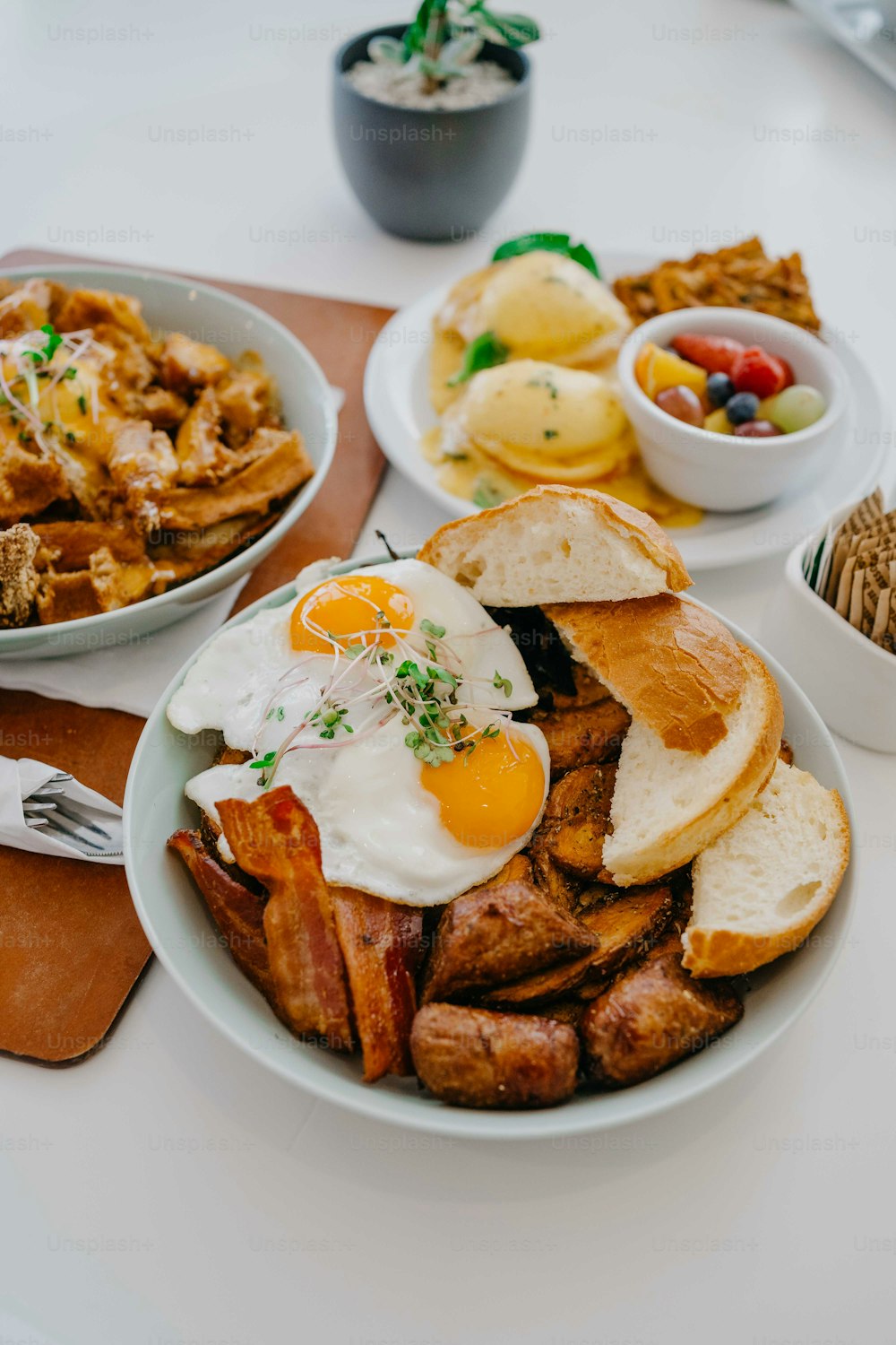 a white plate topped with a sandwich and eggs