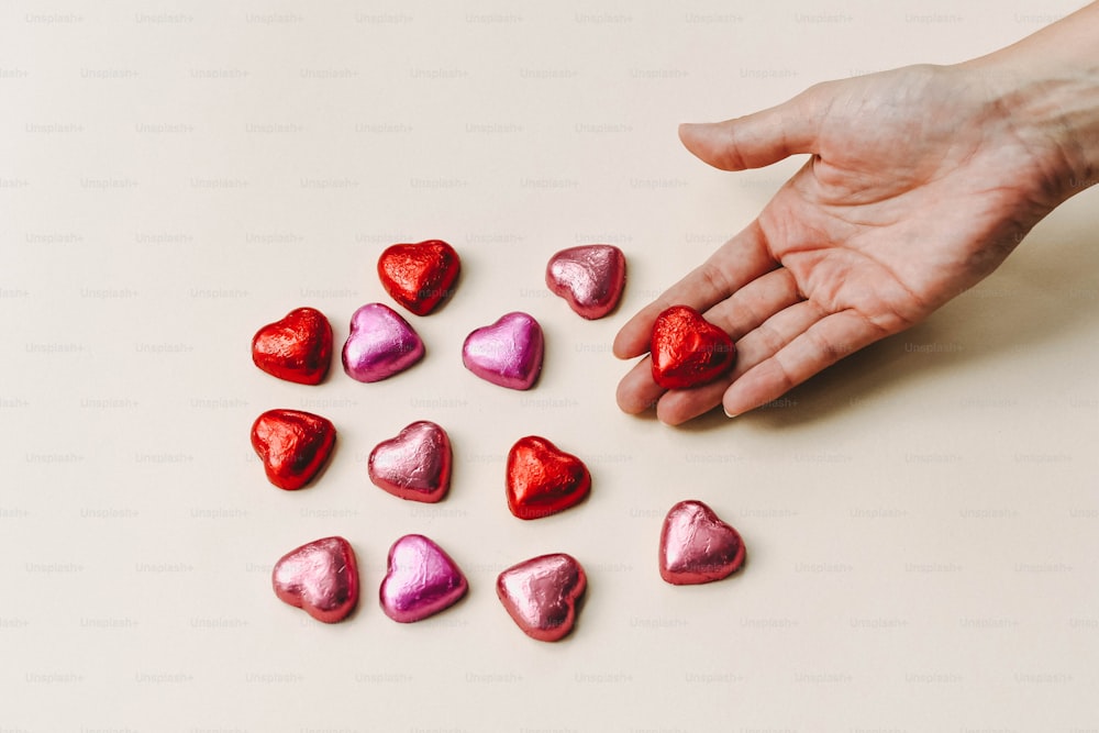 Una mano que busca un caramelo en forma de corazón