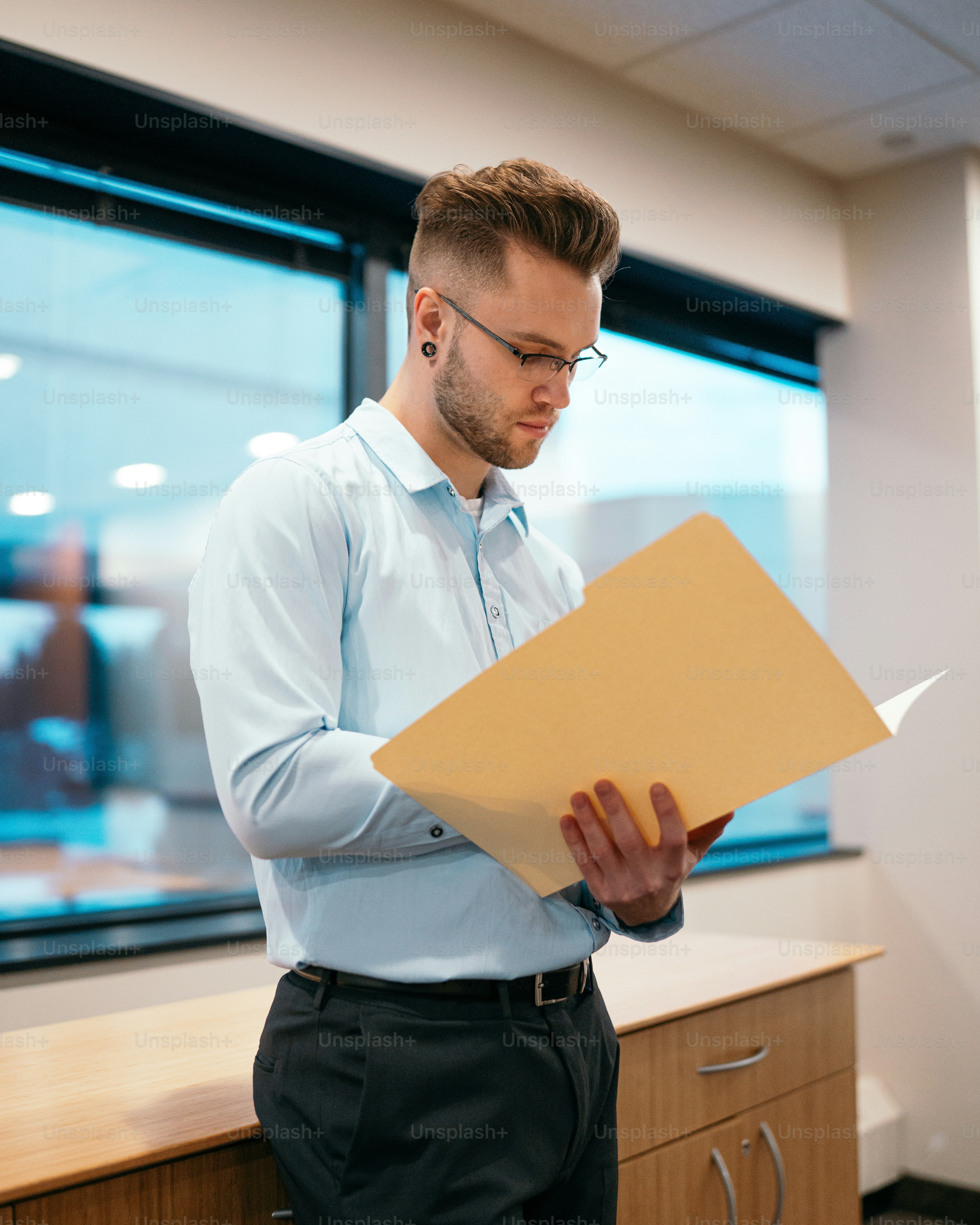a man in a blue shirt is holding a box