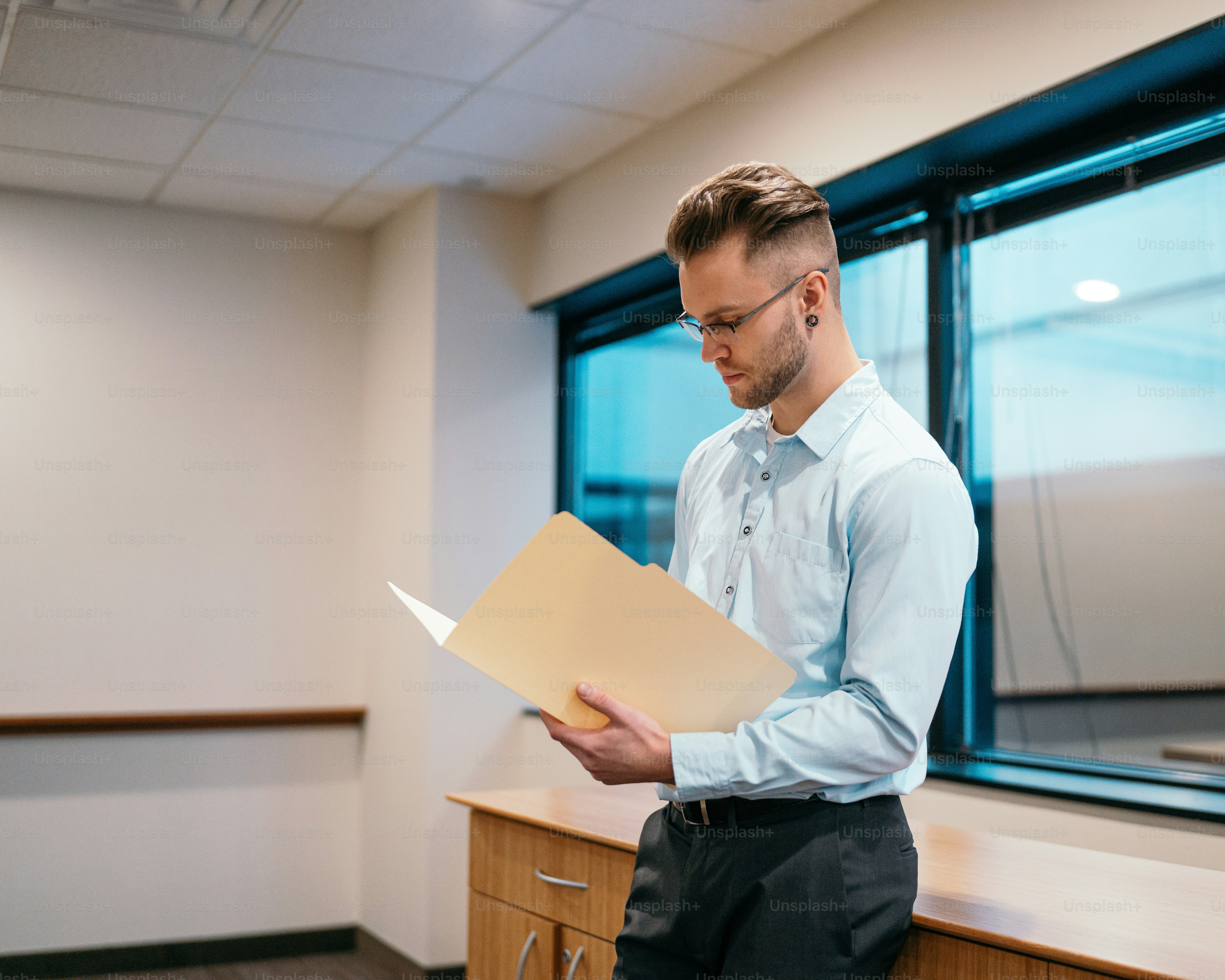 a man holding a piece of paper in an office