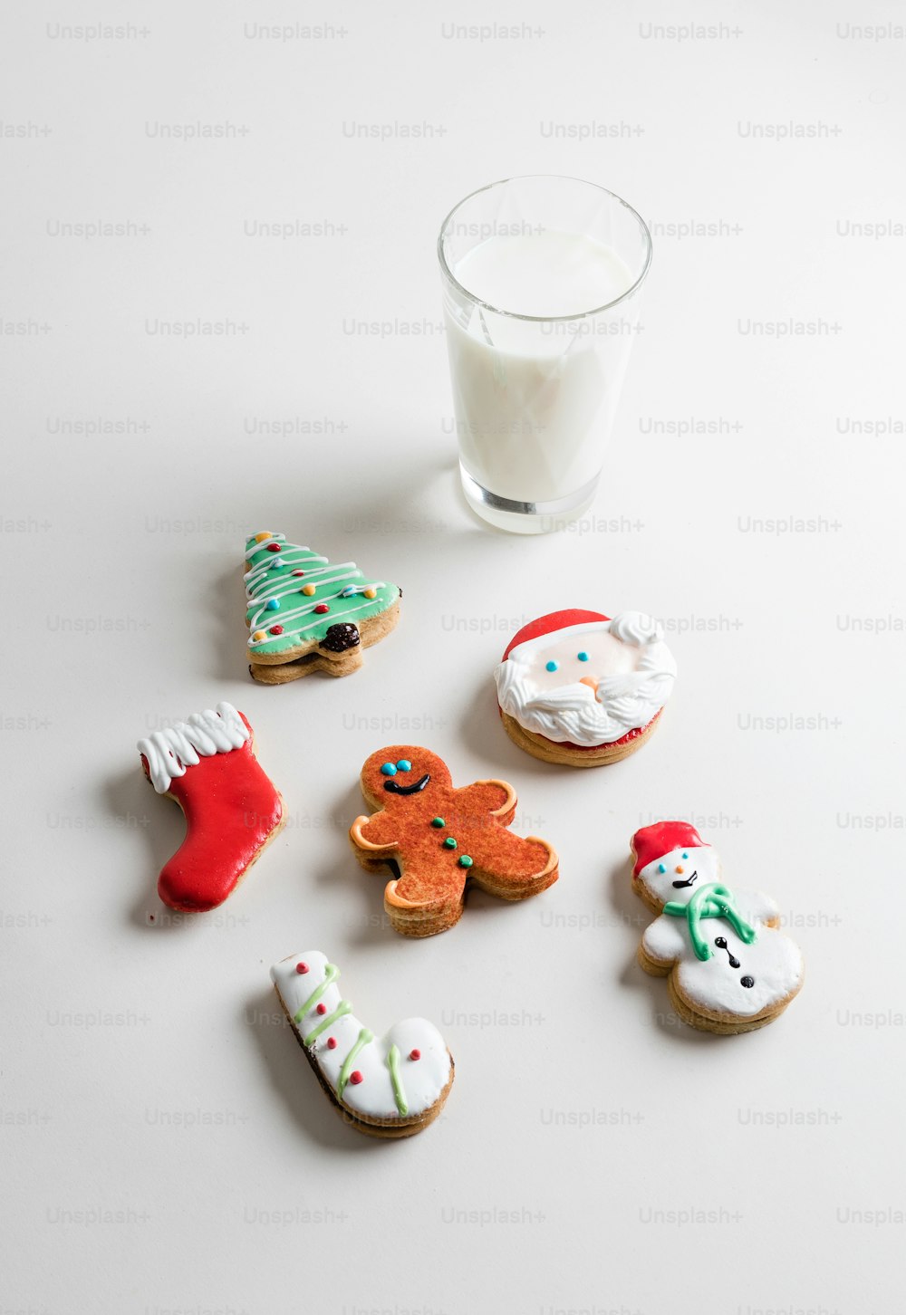 a glass of milk and some decorated cookies