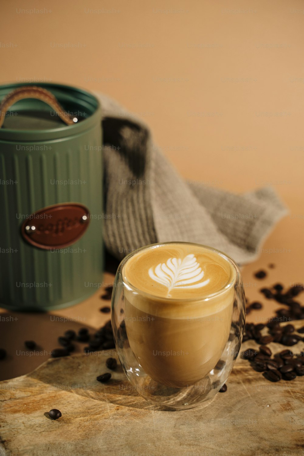 a cup of coffee with a leaf on it