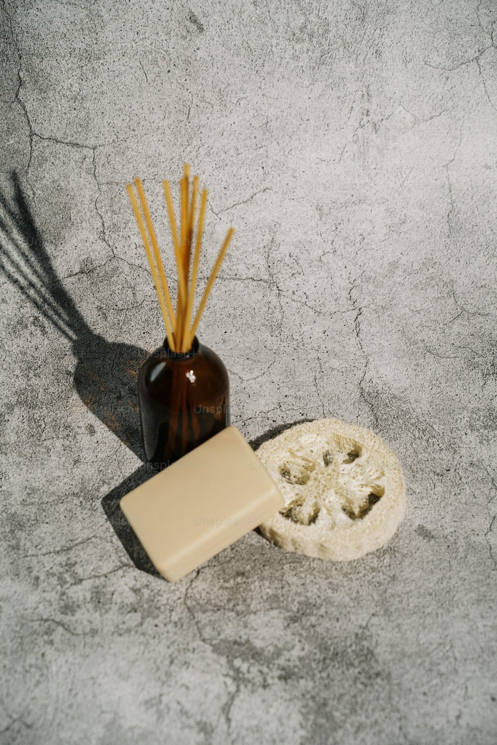 a soap bar next to a brown vase with reeds