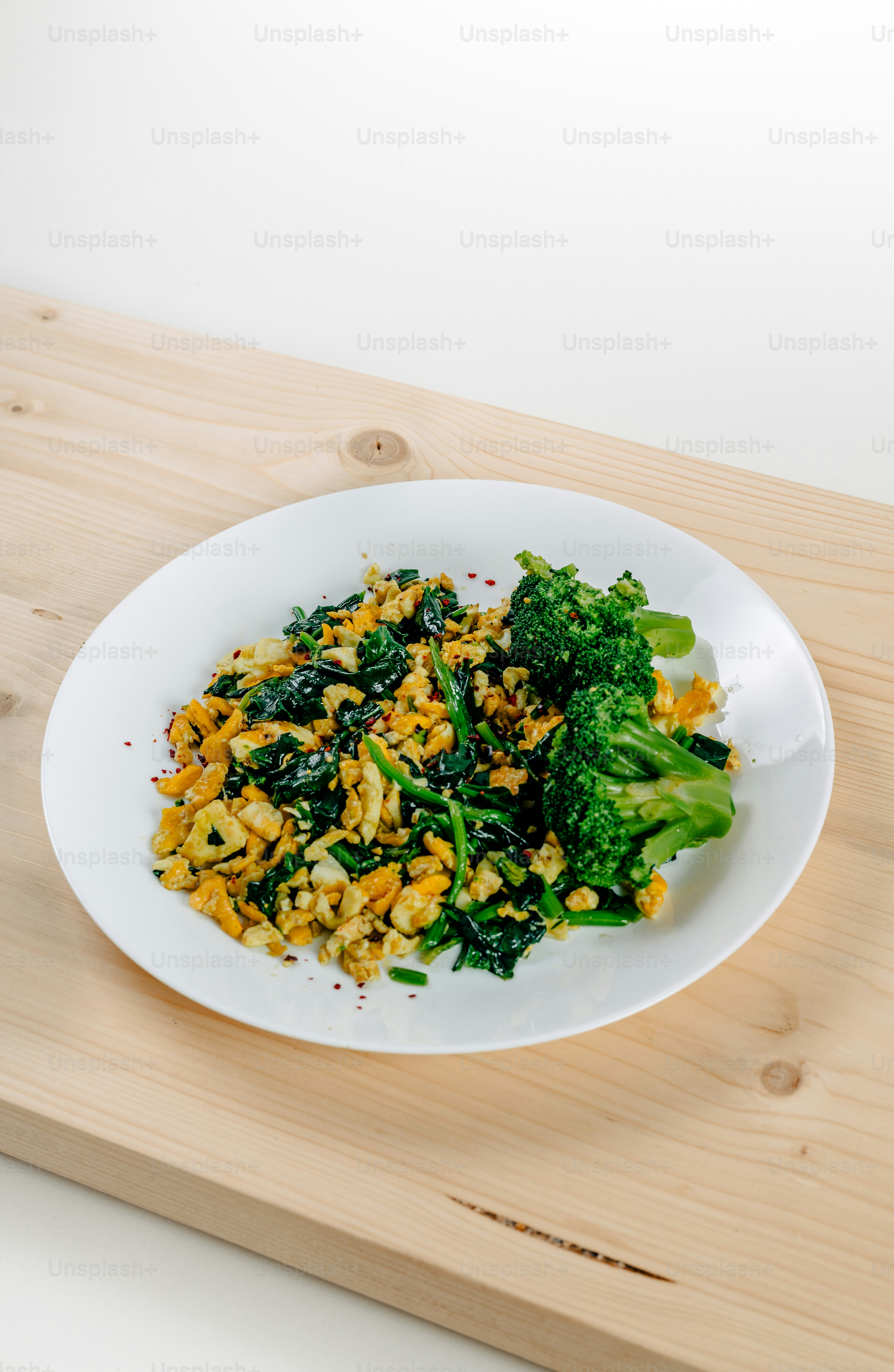 a white plate topped with broccoli and rice