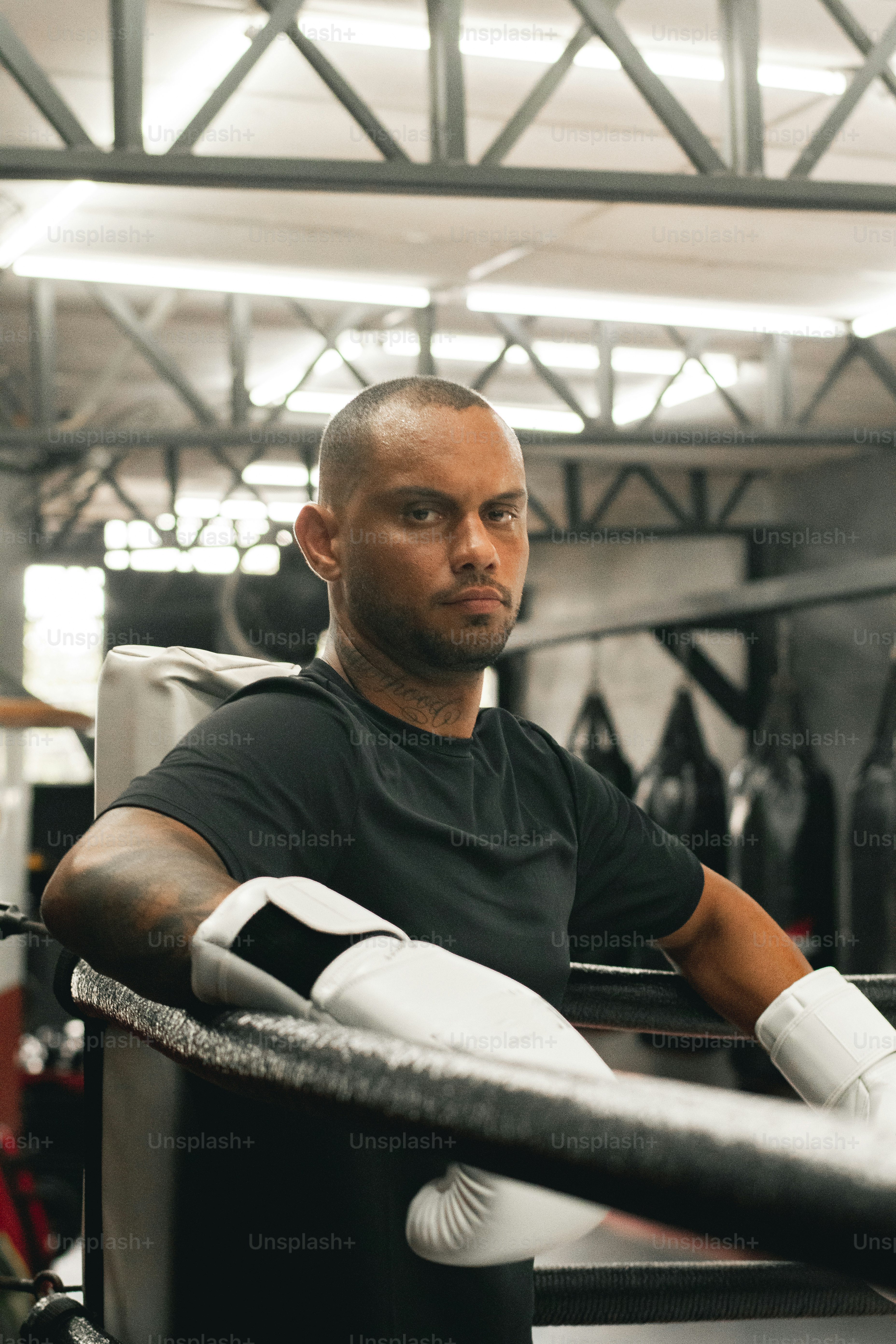 Ein Mann sitzt in einem Boxring mit Handschuhen
