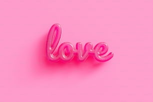 the word love spelled out of balloons on a pink background