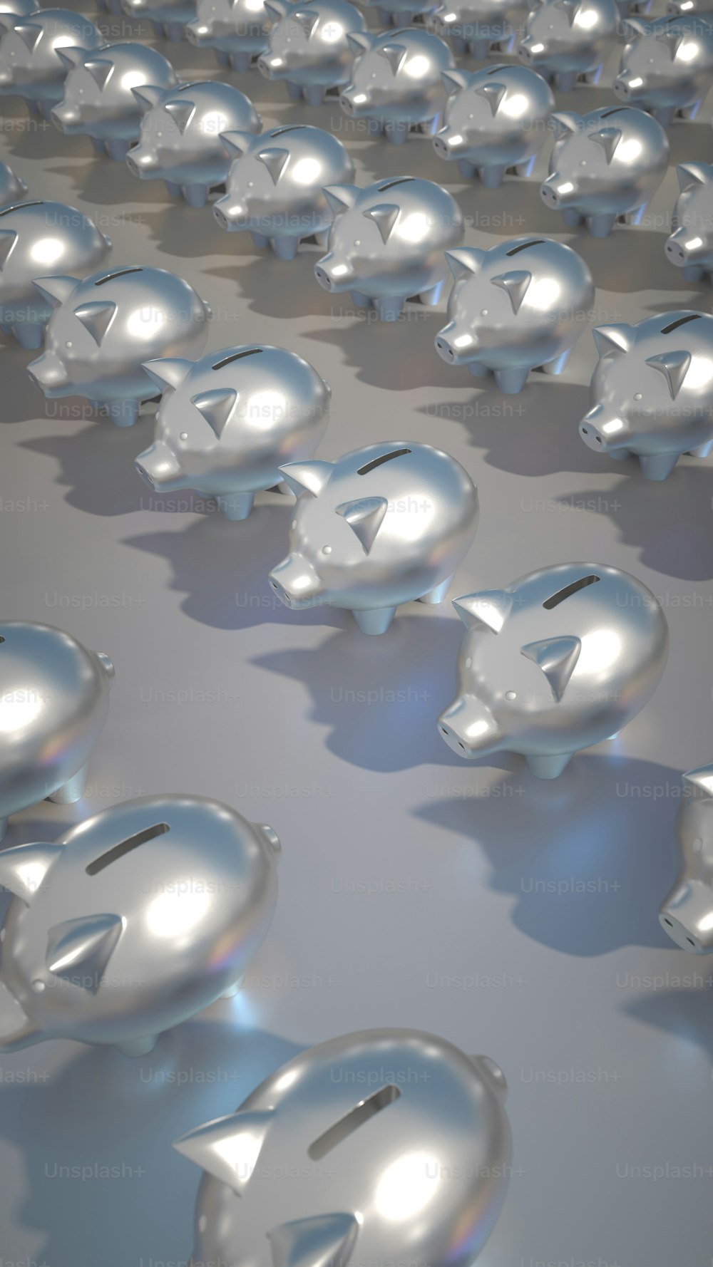 a large group of shiny silver objects on a gray surface