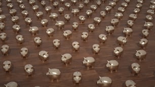 a large number of silver elephants on a wooden floor