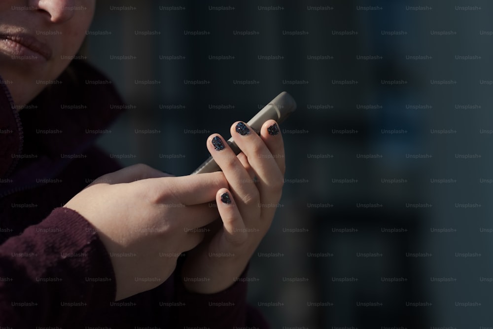 a close up of a person holding a cell phone