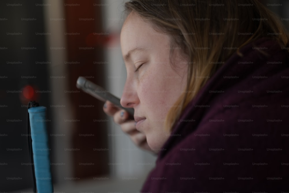 a woman holding a cell phone to her ear