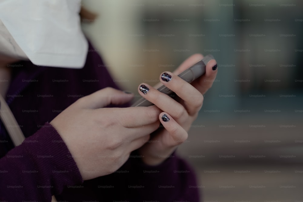 a woman holding a cell phone in her hands