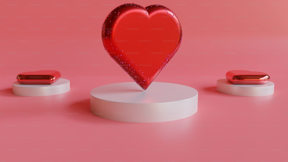 a red heart on top of a white pedestal