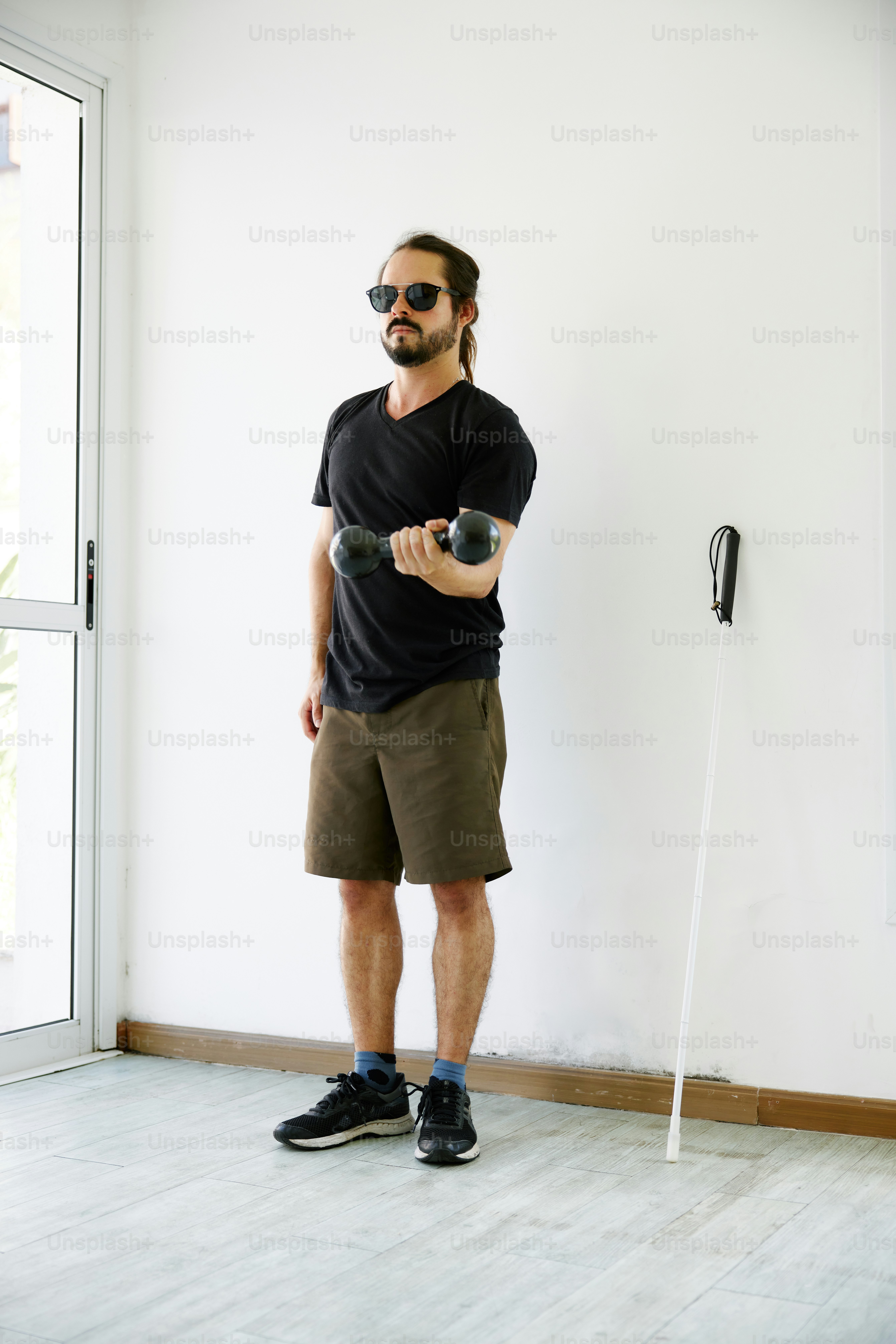 a man standing in front of a white wall