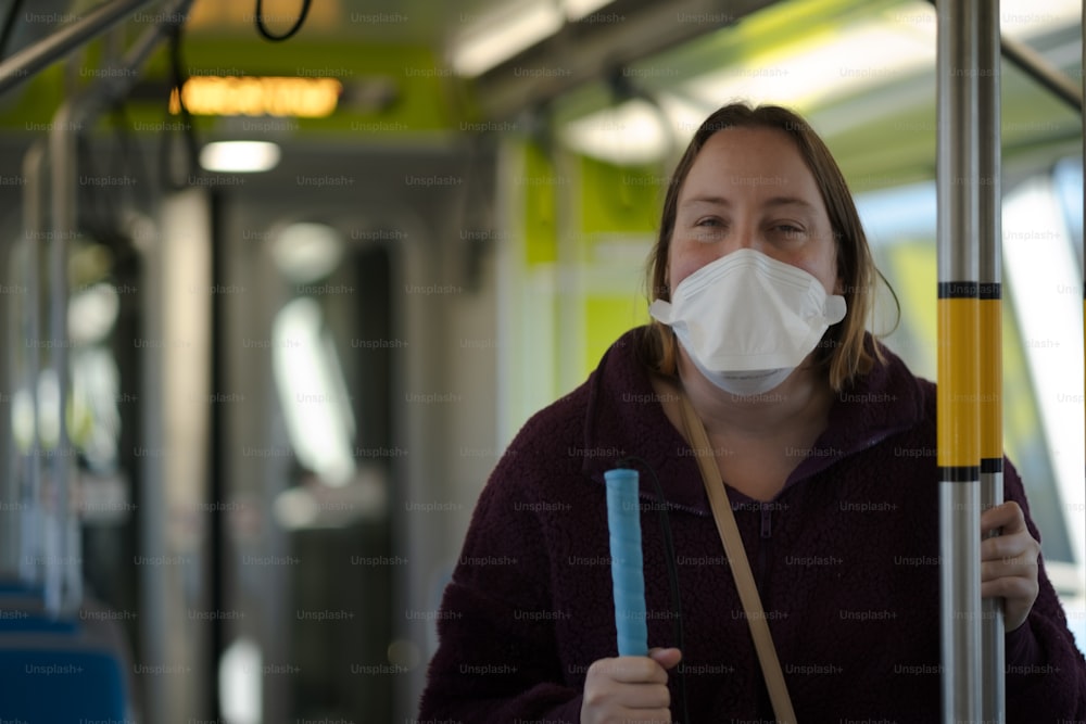 a woman wearing a face mask on a bus