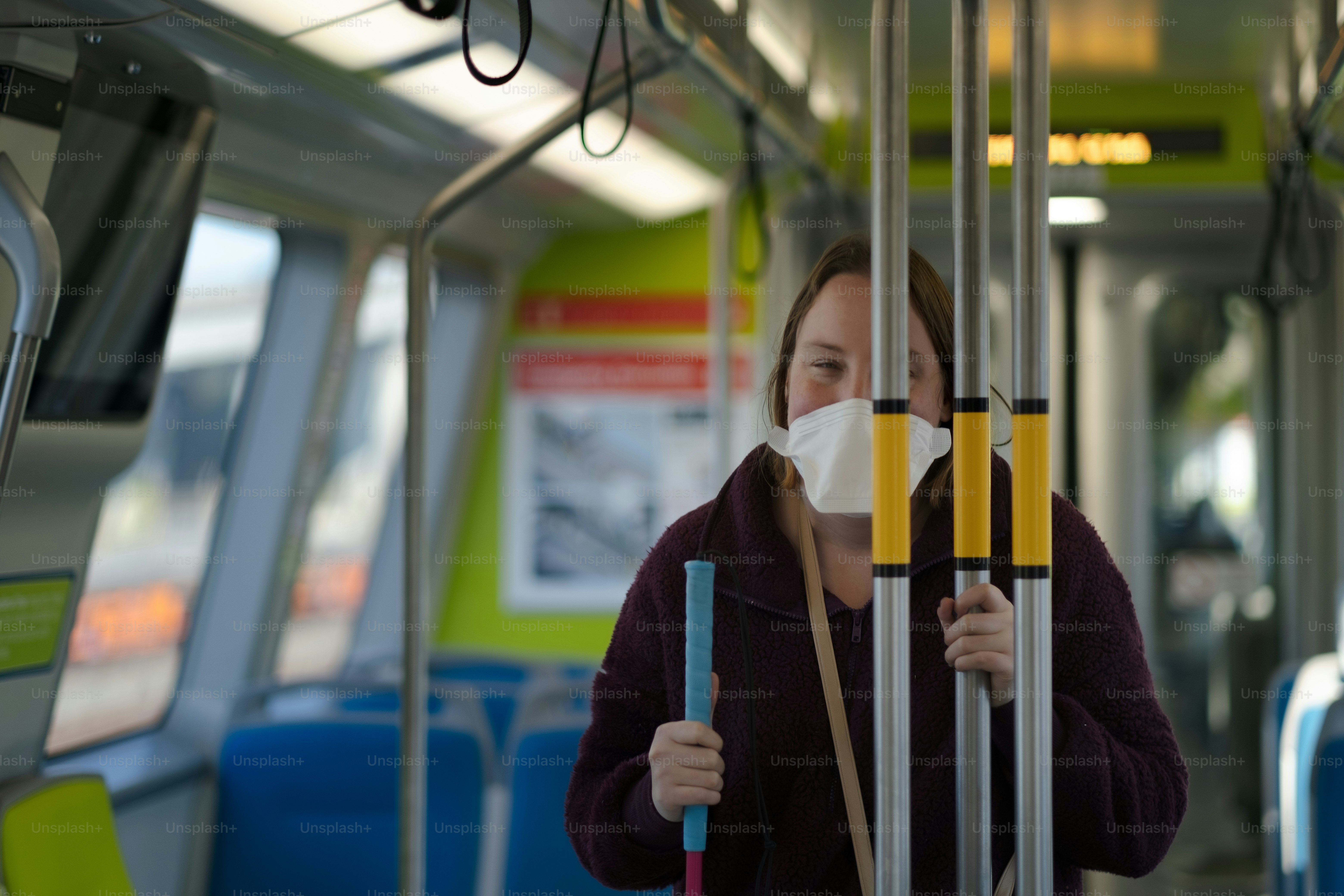 a woman wearing a face mask on a bus