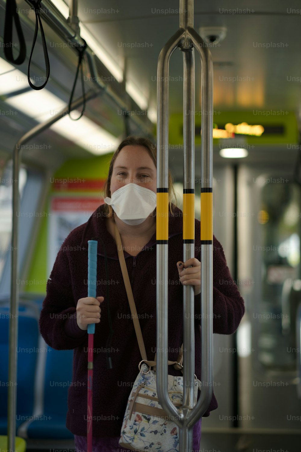 a woman wearing a face mask on a bus