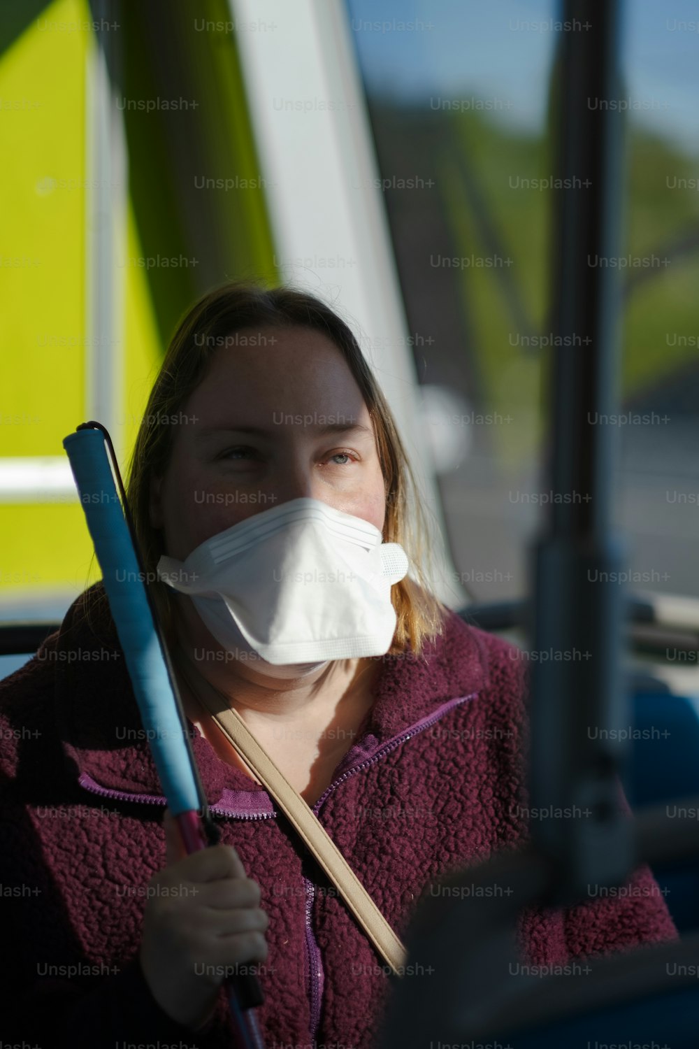 a woman wearing a face mask and holding a stick