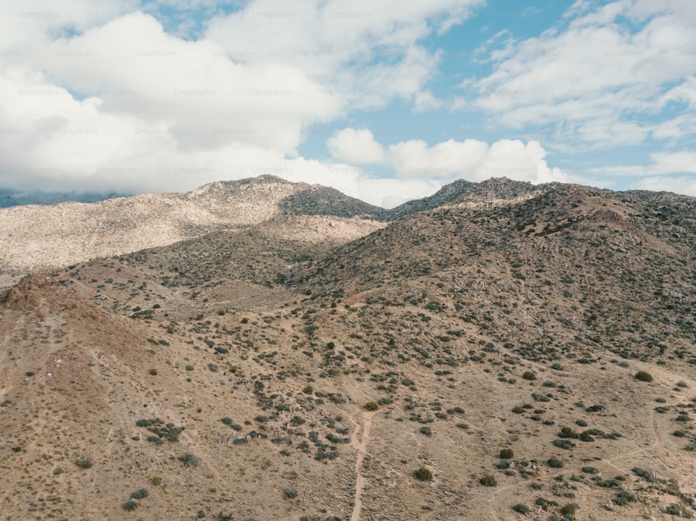 a view of a mountain range with clouds in the sky