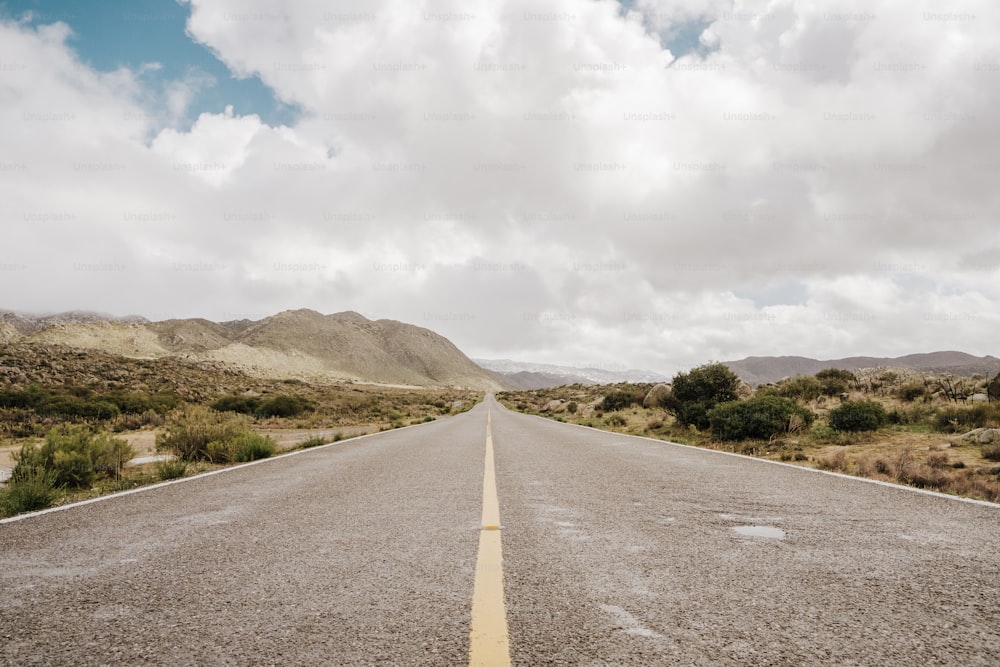 an empty road in the middle of a desert