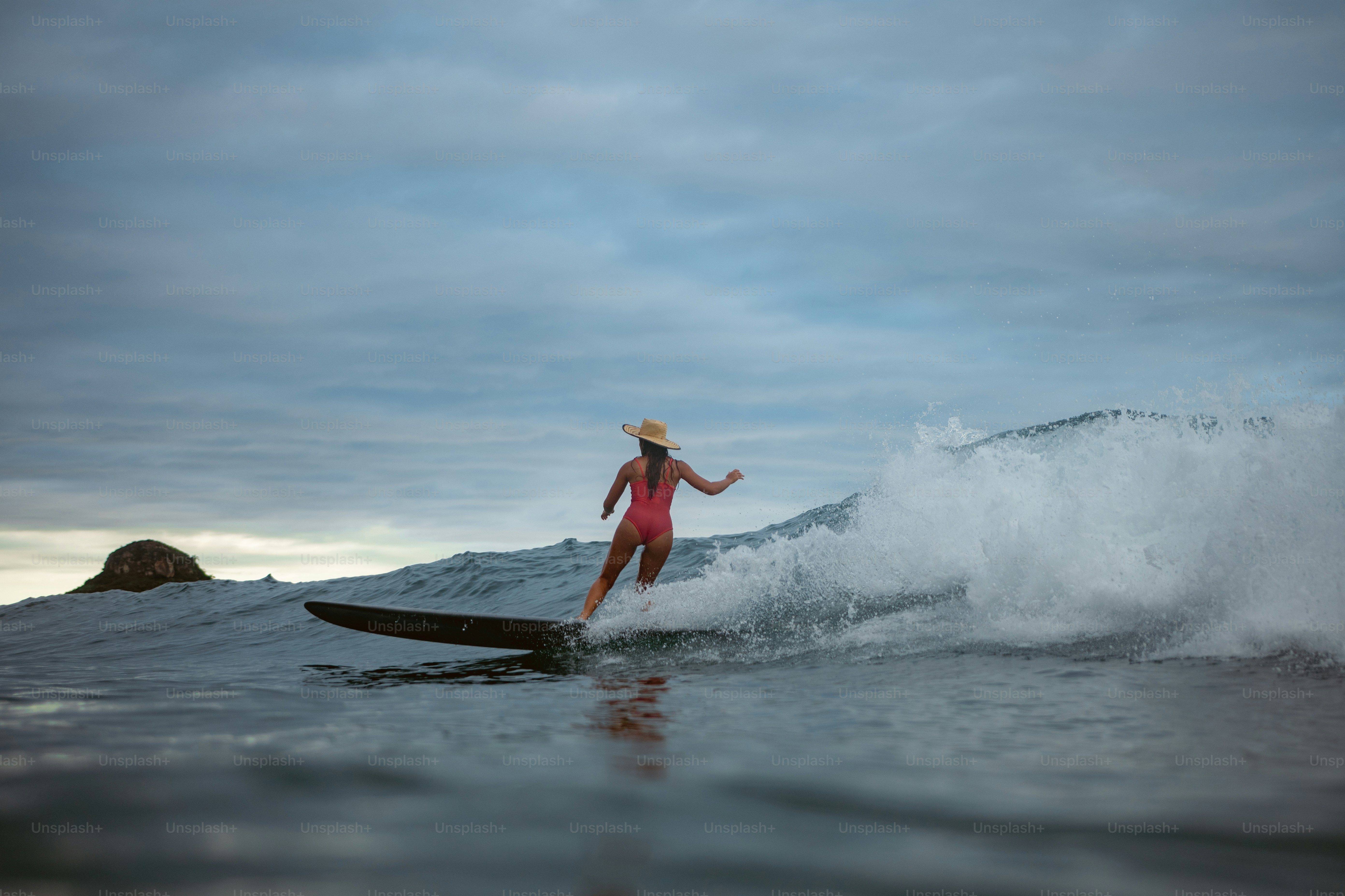 A woman riding a wave on top of a surfboard photo – Outdoor Image on ...