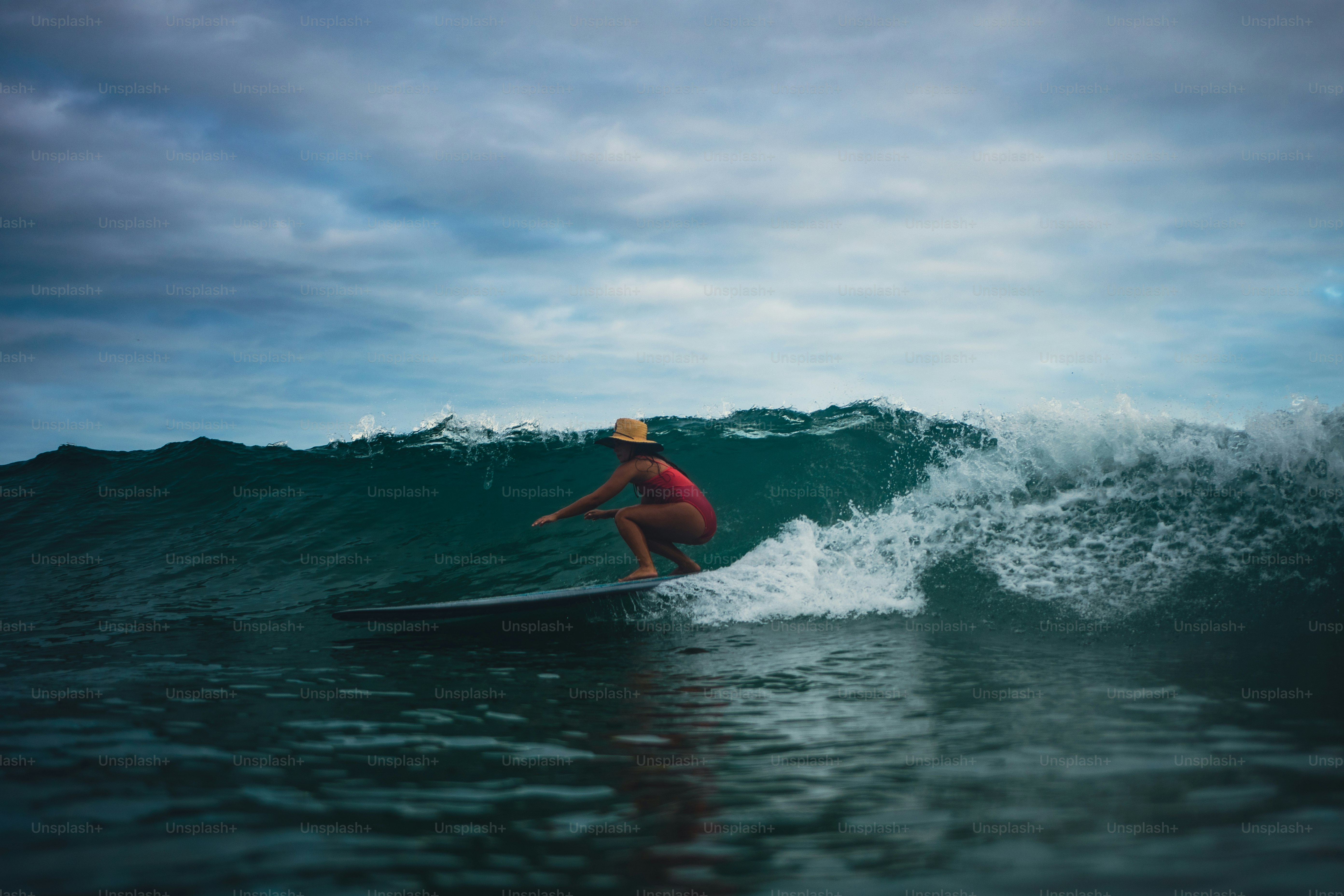 a man riding a wave on top of a surfboard