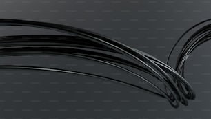 um monte de fios pretos em um fundo cinza