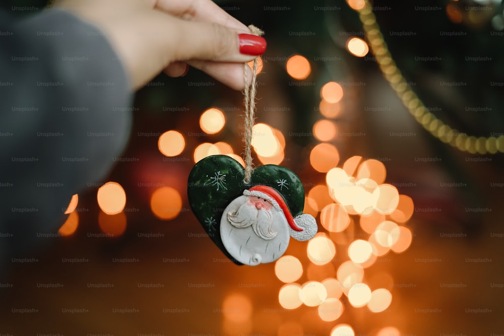 a person holding a christmas ornament in their hand