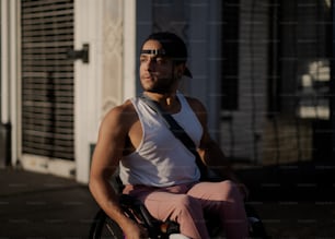 a man sitting in a wheel chair in front of a building