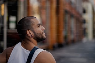 a man with a beard and a white tank top