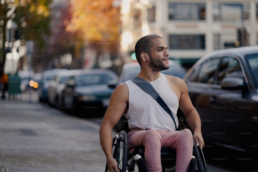 a man in a wheelchair on a city street