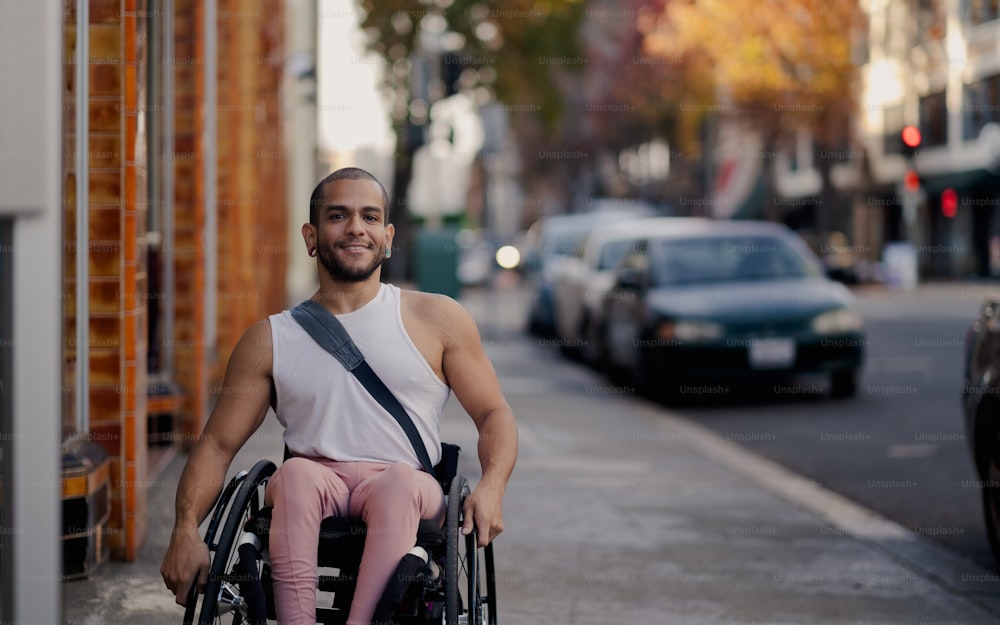 a man in a wheelchair on a city street