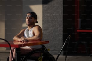 a man sitting at a table with his arms crossed