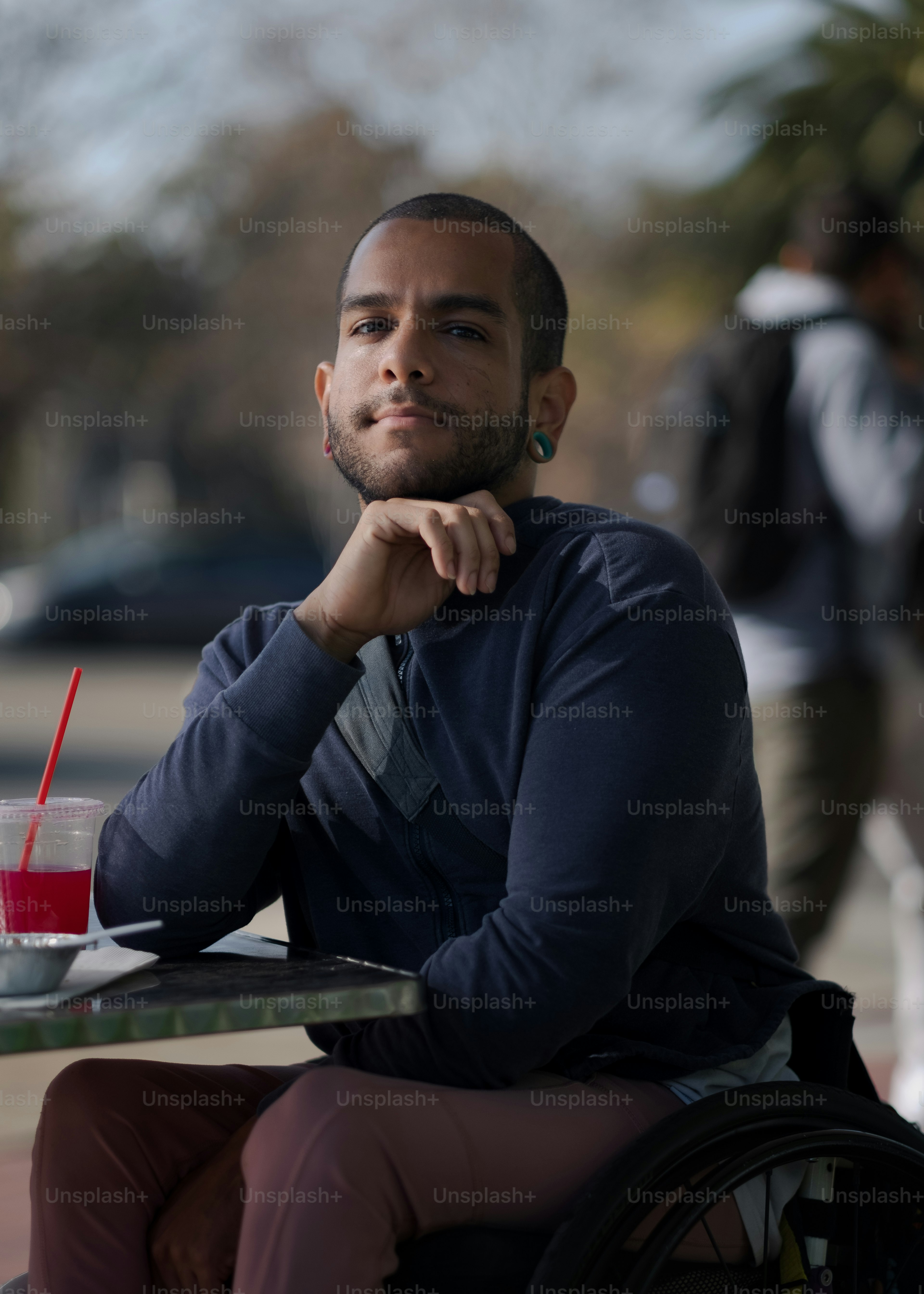 a man sitting at a table with a drink in front of him