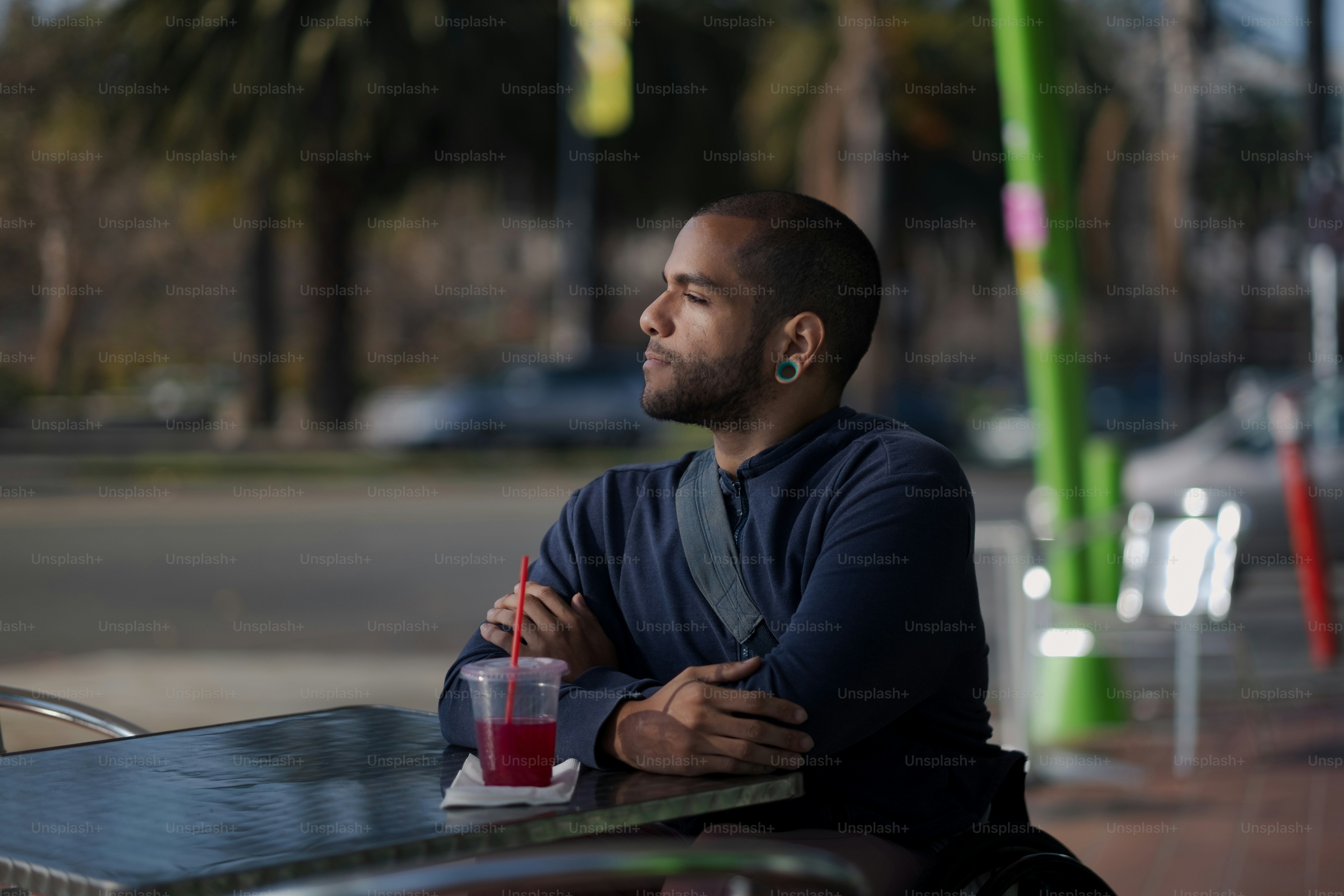 a man sitting at a table with a drink