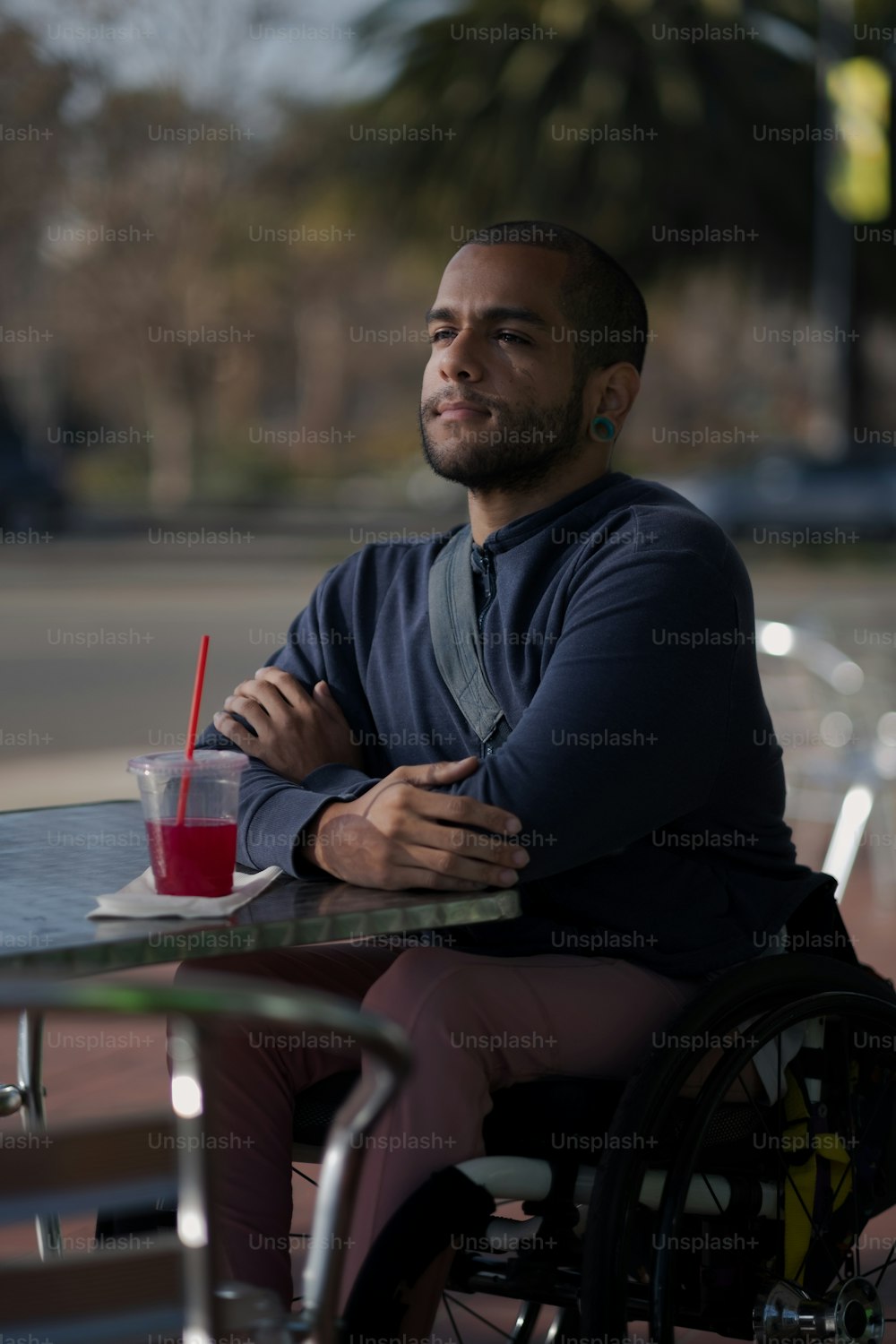 a man sitting at a table with a drink in his hand