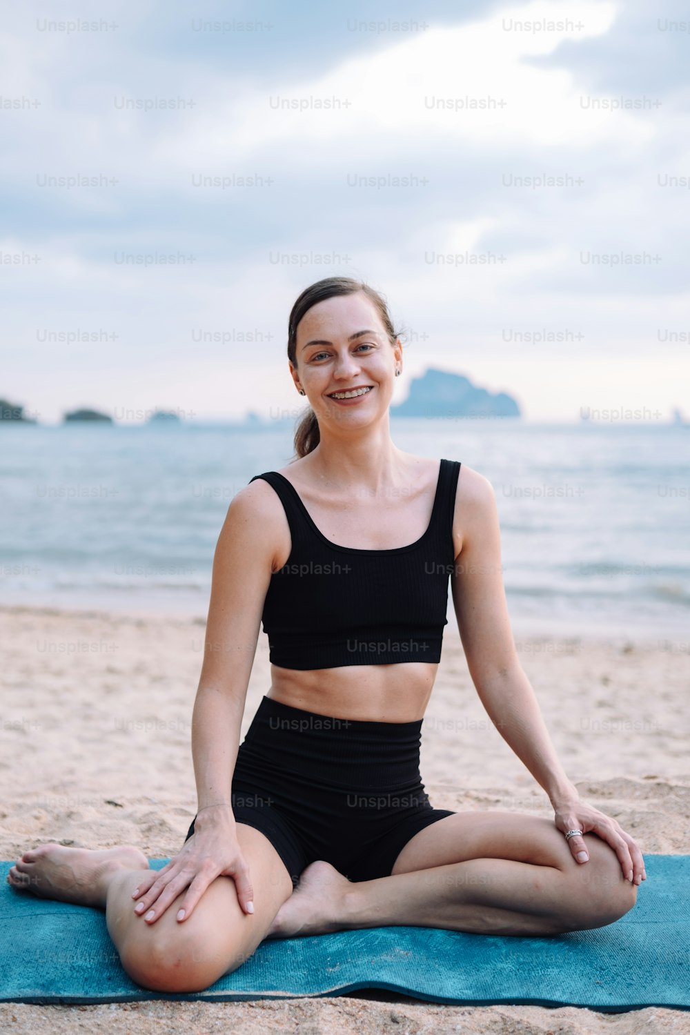A woman doing a yoga pose on a beach photo – Fitness Image on Unsplash