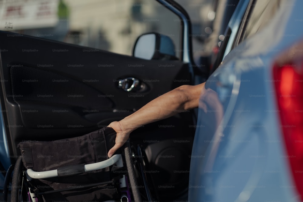 a person in a wheel chair getting out of a car