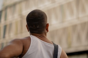 the back of a man's head with a building in the background