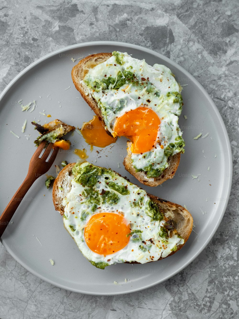 two pieces of toast with an egg on top